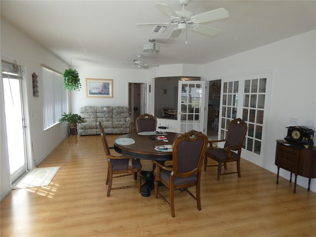 dining room with ceiling fan, french doors, visible vents, and light wood-style floors