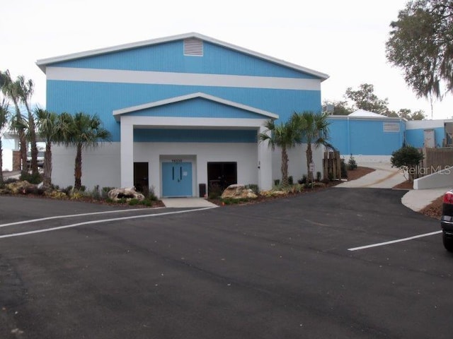 view of building exterior with uncovered parking