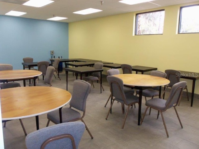 dining space with a paneled ceiling