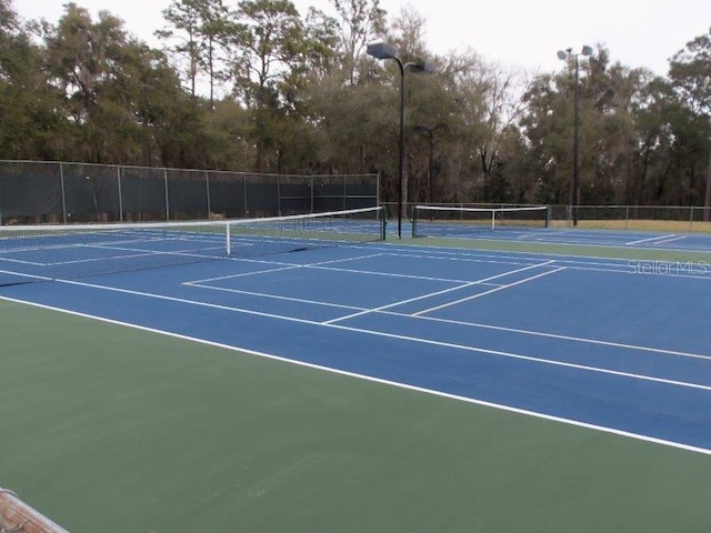 view of tennis court with fence