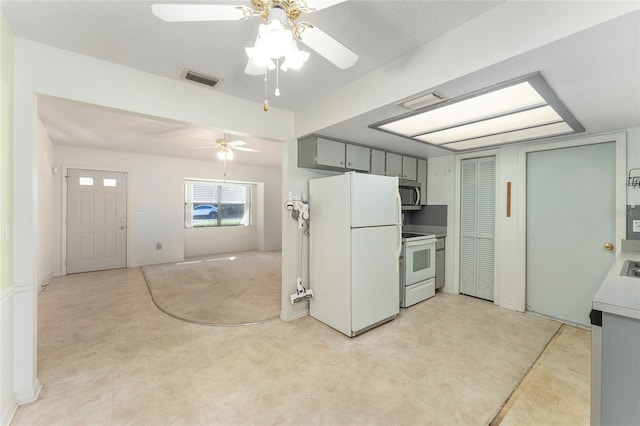 kitchen featuring white appliances, ceiling fan, open floor plan, gray cabinets, and light countertops