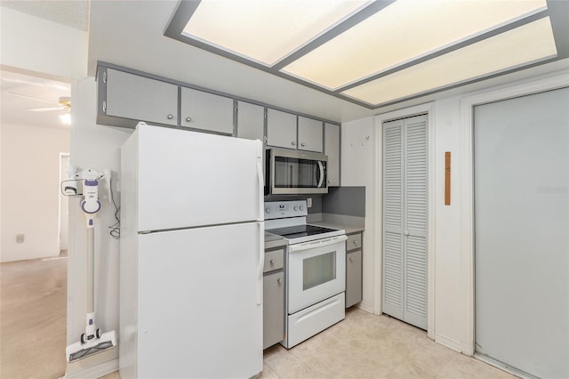 kitchen featuring ceiling fan, white appliances, and gray cabinets