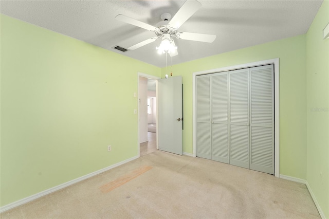 unfurnished bedroom featuring light carpet, a closet, visible vents, and baseboards