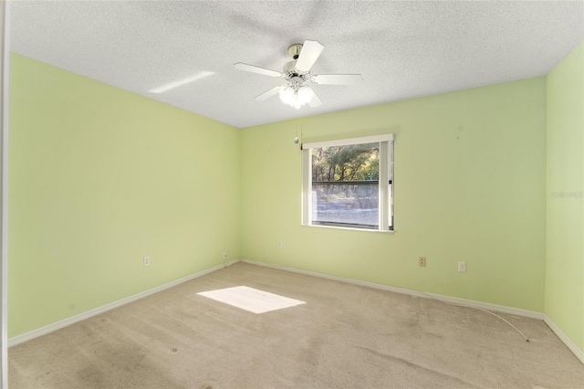 unfurnished room featuring light carpet, baseboards, a ceiling fan, and a textured ceiling