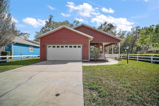 view of front facade featuring a front yard, fence, driveway, and an attached garage