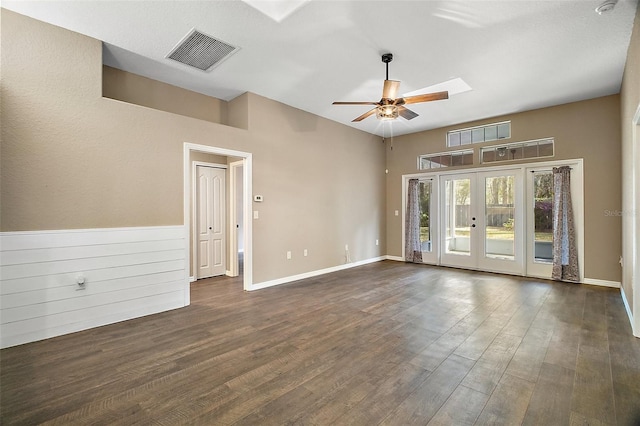 spare room with a ceiling fan, visible vents, dark wood-type flooring, and french doors