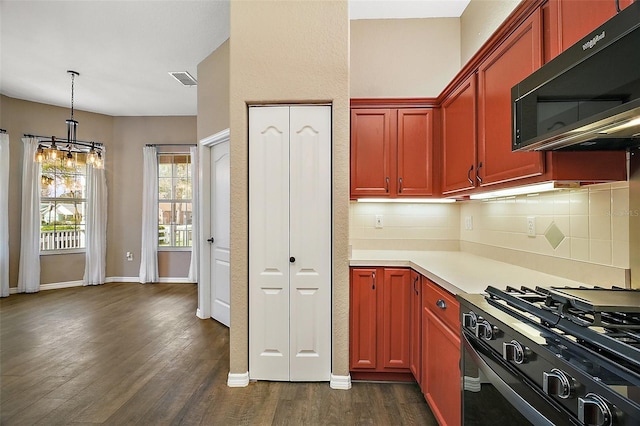 kitchen with dark wood-style flooring, light countertops, dark brown cabinets, black range with gas stovetop, and decorative backsplash