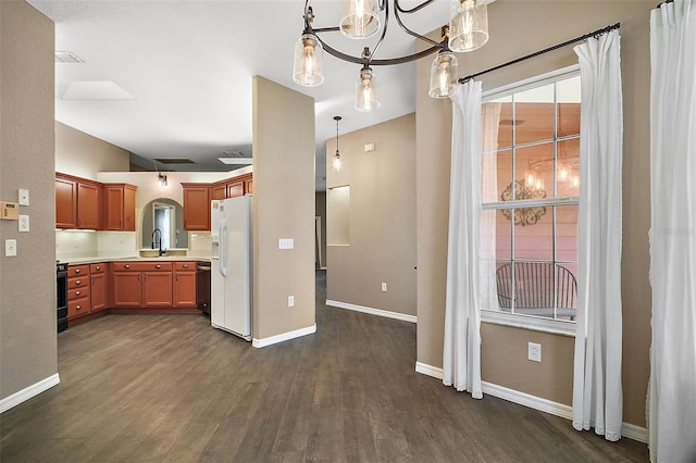 kitchen with dark wood-style flooring, a sink, light countertops, black range, and white fridge with ice dispenser