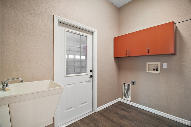 clothes washing area with washer hookup, dark wood finished floors, a sink, electric dryer hookup, and baseboards