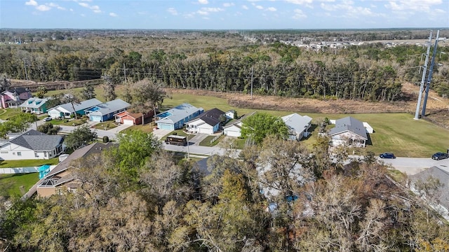 birds eye view of property featuring a residential view and a wooded view