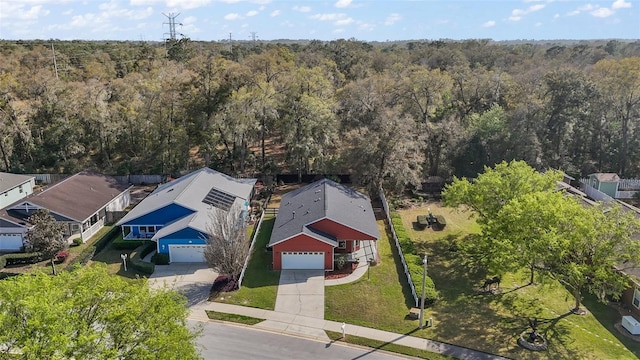 birds eye view of property featuring a view of trees