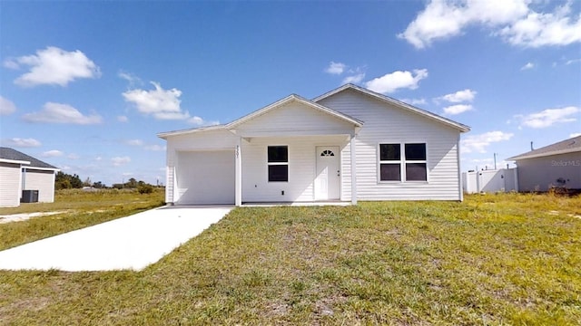 ranch-style home with a garage, a front yard, and concrete driveway