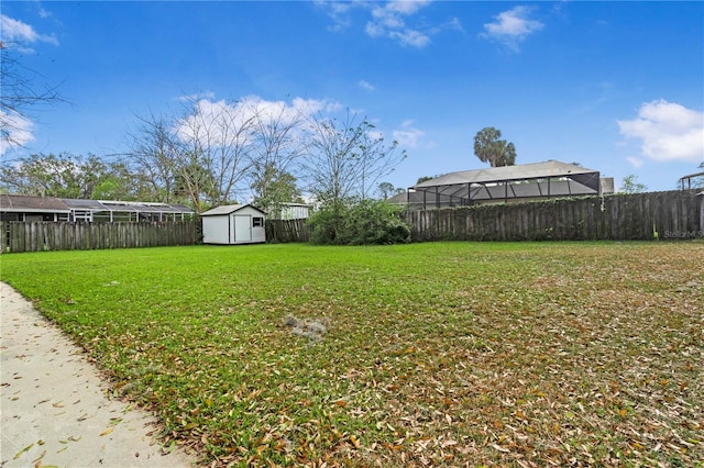 view of yard featuring a fenced backyard, an outdoor structure, and a shed