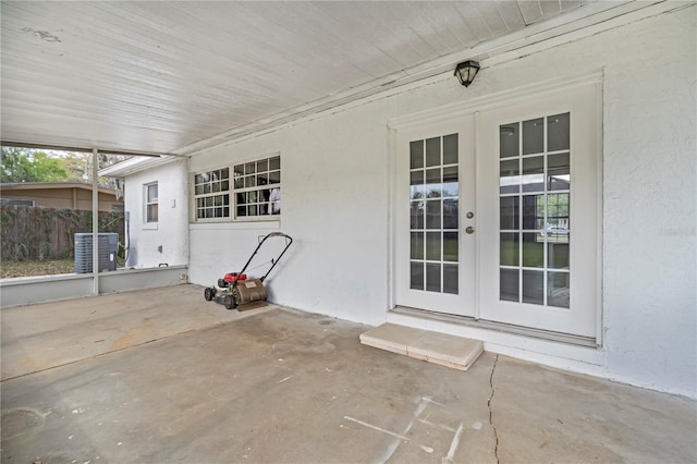 view of patio / terrace with french doors, central AC unit, and fence
