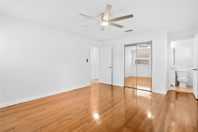 unfurnished bedroom featuring visible vents, baseboards, ceiling fan, light wood-style floors, and a closet