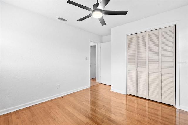unfurnished bedroom with visible vents, baseboards, a closet, and light wood-style flooring