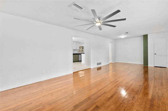 interior space featuring a ceiling fan, light wood-style floors, and visible vents