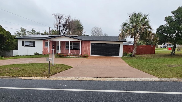 31 Roosevelt Blvd, Beverly Hills, FL 34465 - view of front of home featuring a front yard, fence, solar panels, concrete driveway, and a garage