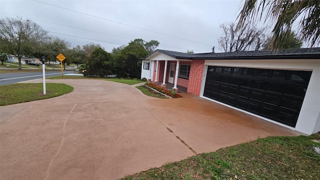 31 Roosevelt Blvd, Beverly Hills, FL 34465 - view of front of house featuring a garage and driveway