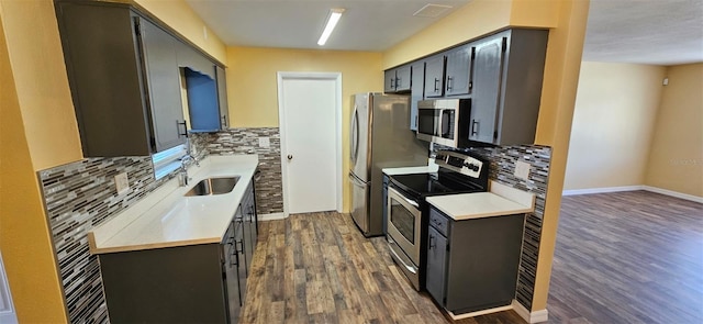 31 Roosevelt Blvd, Beverly Hills, FL 34465 - kitchen featuring light countertops, decorative backsplash, appliances with stainless steel finishes, dark wood-style floors, and a sink