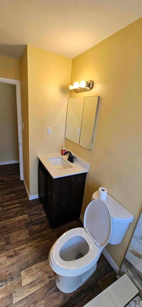 31 Roosevelt Blvd, Beverly Hills, FL 34465 - bathroom with baseboards, toilet, wood finished floors, and vanity