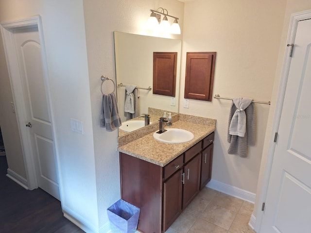 bathroom featuring vanity, baseboards, and tile patterned floors