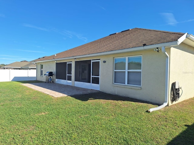 back of house featuring a patio, a shingled roof, fence, a yard, and stucco siding