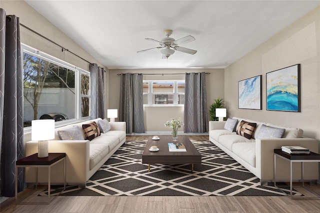 living area with ceiling fan and wood finished floors