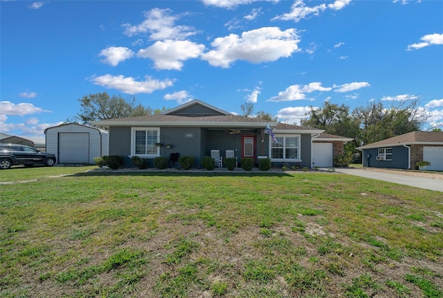 ranch-style home featuring driveway, an attached garage, an outdoor structure, a front yard, and stucco siding