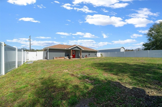 view of yard with a fenced backyard and a gate