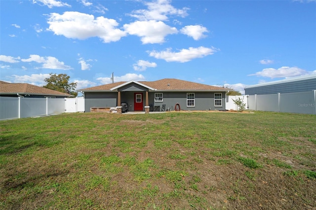 back of property with a yard, a patio area, a fenced backyard, and stucco siding