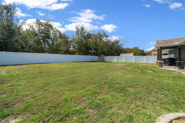 view of yard featuring a patio area and a fenced backyard