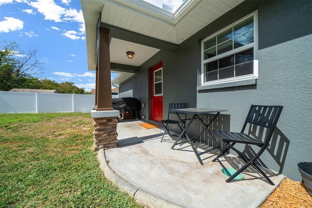 view of patio / terrace with outdoor dining area, fence, and a grill