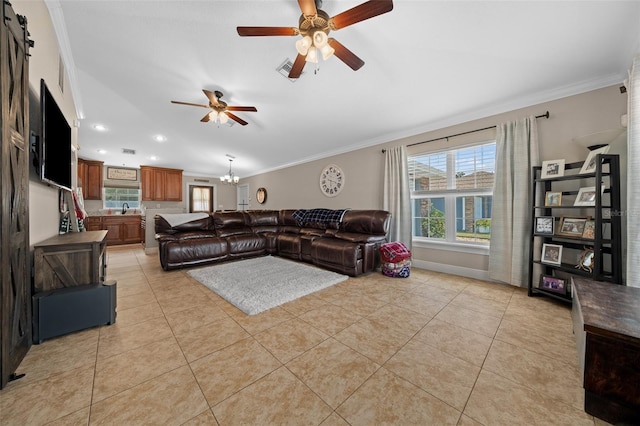 living area featuring ceiling fan with notable chandelier, ornamental molding, and light tile patterned flooring