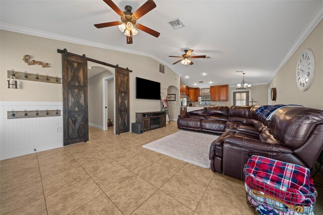 living area with lofted ceiling, light tile patterned floors, a barn door, visible vents, and crown molding