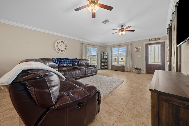 living room featuring light tile patterned floors, a ceiling fan, visible vents, and crown molding