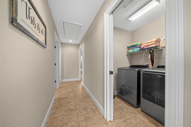 laundry room featuring light tile patterned floors, independent washer and dryer, attic access, and baseboards