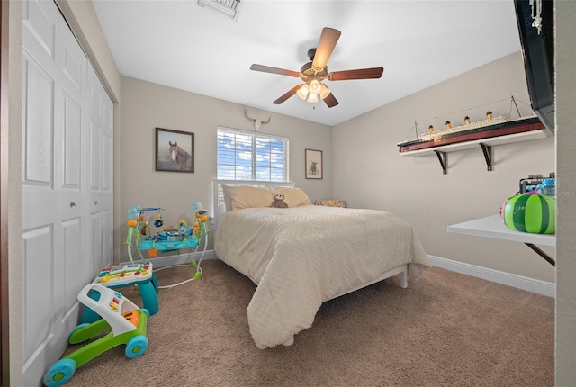 carpeted bedroom featuring a ceiling fan, a closet, visible vents, and baseboards