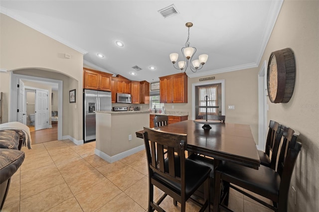 dining room with lofted ceiling, light tile patterned flooring, visible vents, and ornamental molding