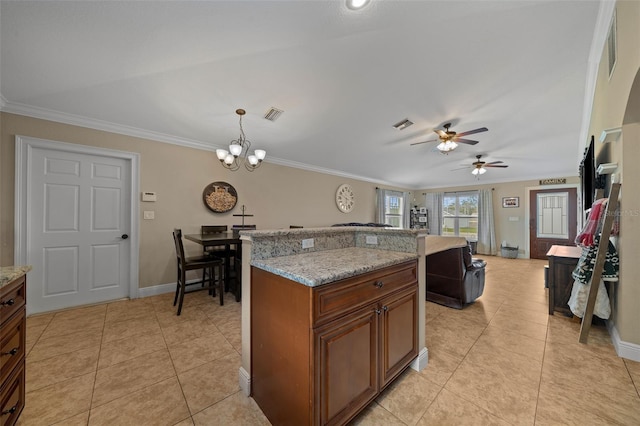 kitchen featuring visible vents, ornamental molding, brown cabinetry, and light tile patterned flooring