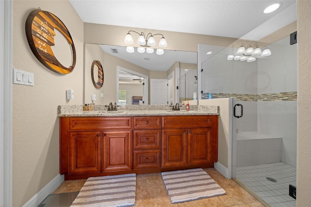 full bath featuring double vanity, a sink, visible vents, and a shower stall