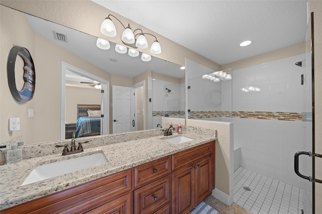 ensuite bathroom featuring ensuite bath, a sink, visible vents, and a shower stall