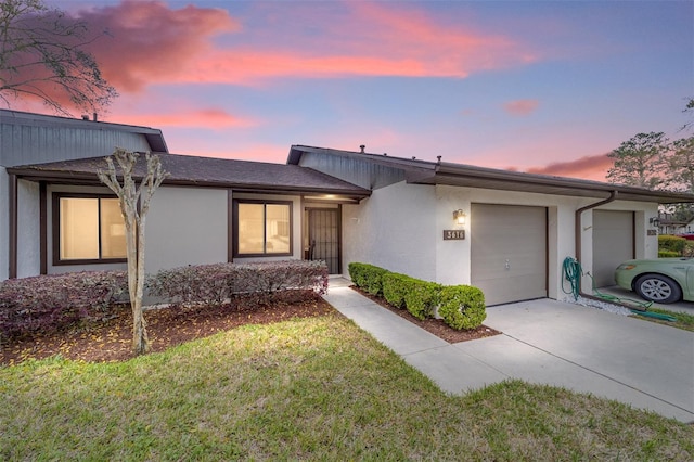 view of front of property with an attached garage, concrete driveway, and stucco siding