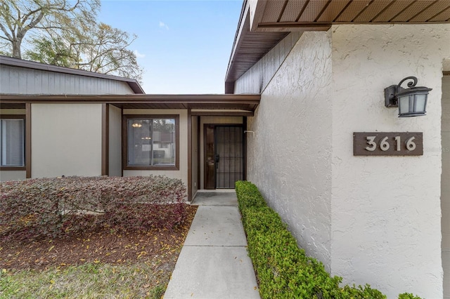 entrance to property with stucco siding