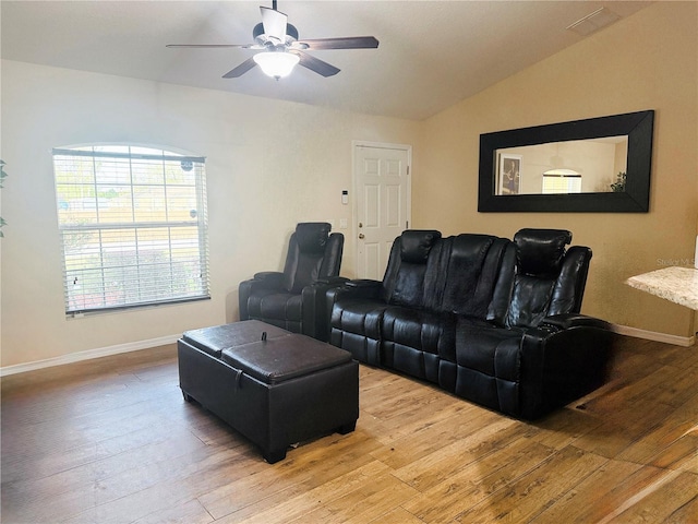 living room with lofted ceiling, ceiling fan, baseboards, and hardwood / wood-style flooring