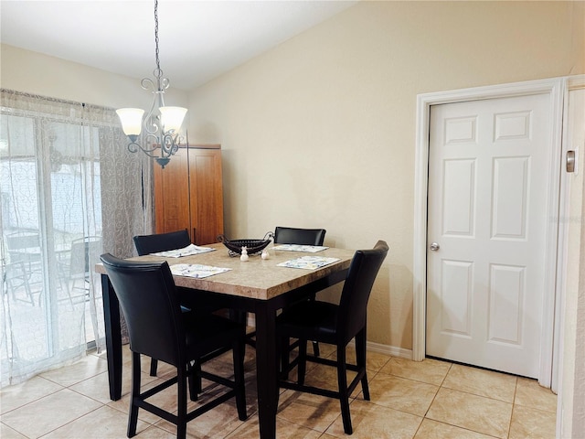 dining space featuring light tile patterned floors, baseboards, and a chandelier