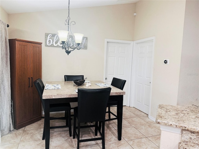 dining room with light tile patterned floors, high vaulted ceiling, and an inviting chandelier