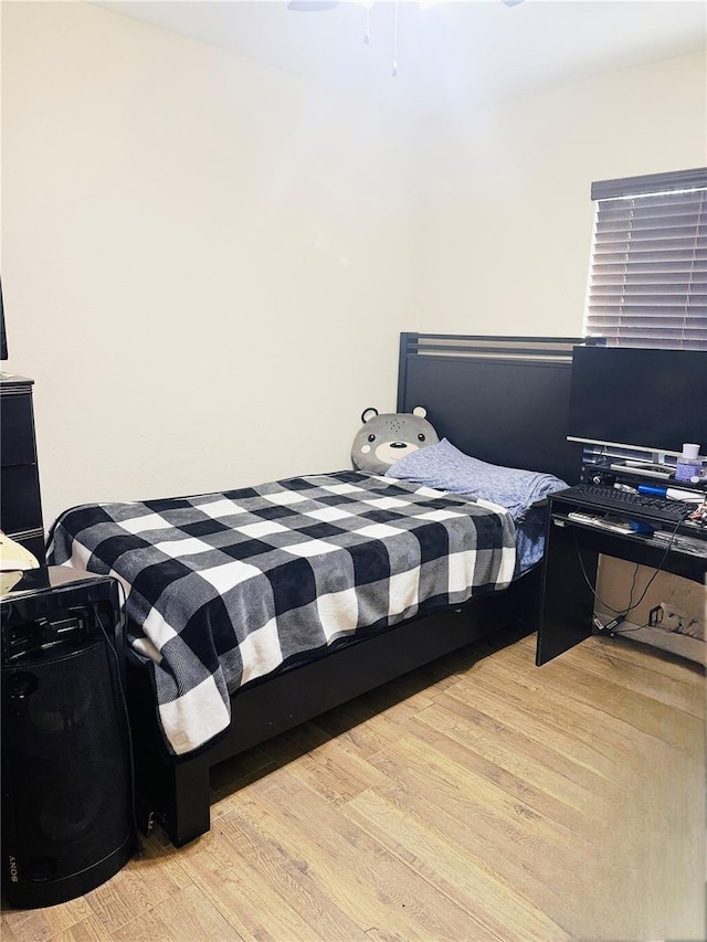 bedroom with wood finished floors