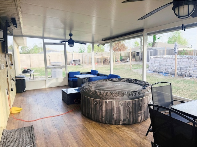 sunroom / solarium with a ceiling fan