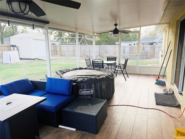 sunroom / solarium with a ceiling fan